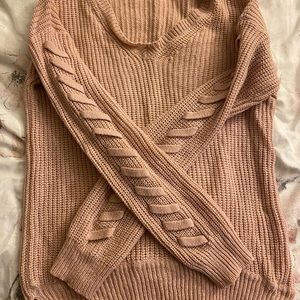 Pink sweater with ties on sleeves. Worn a few times very good condition